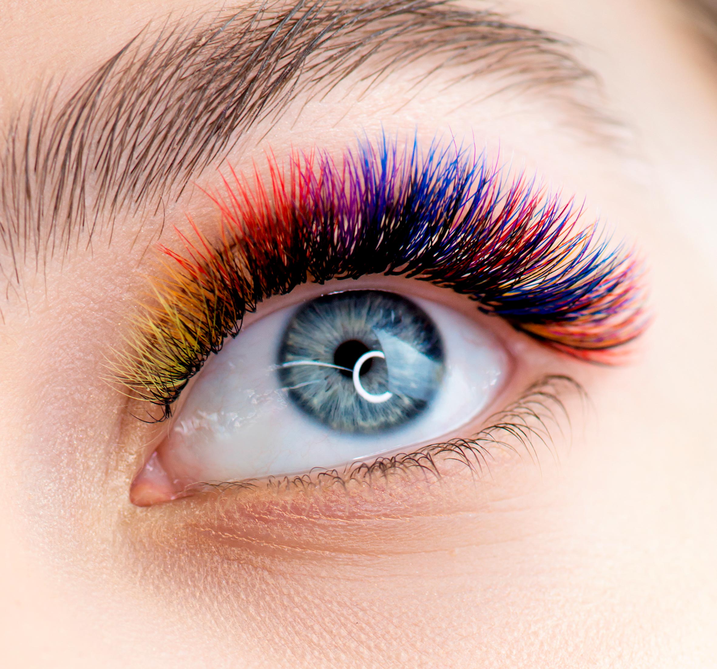 a closeup of an eye with colored lash extensions