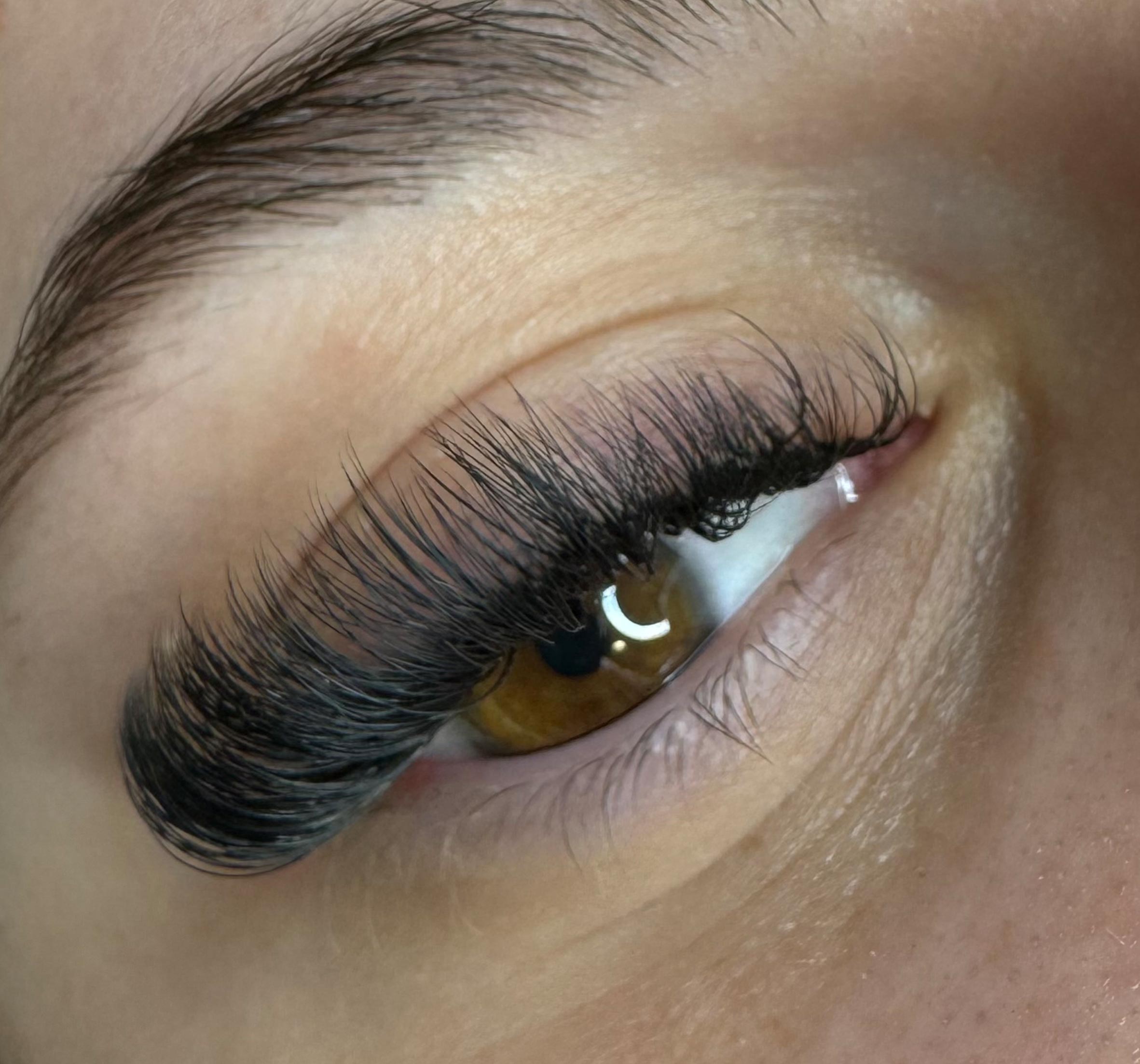 a closeup of the eye with eyelash extensions on