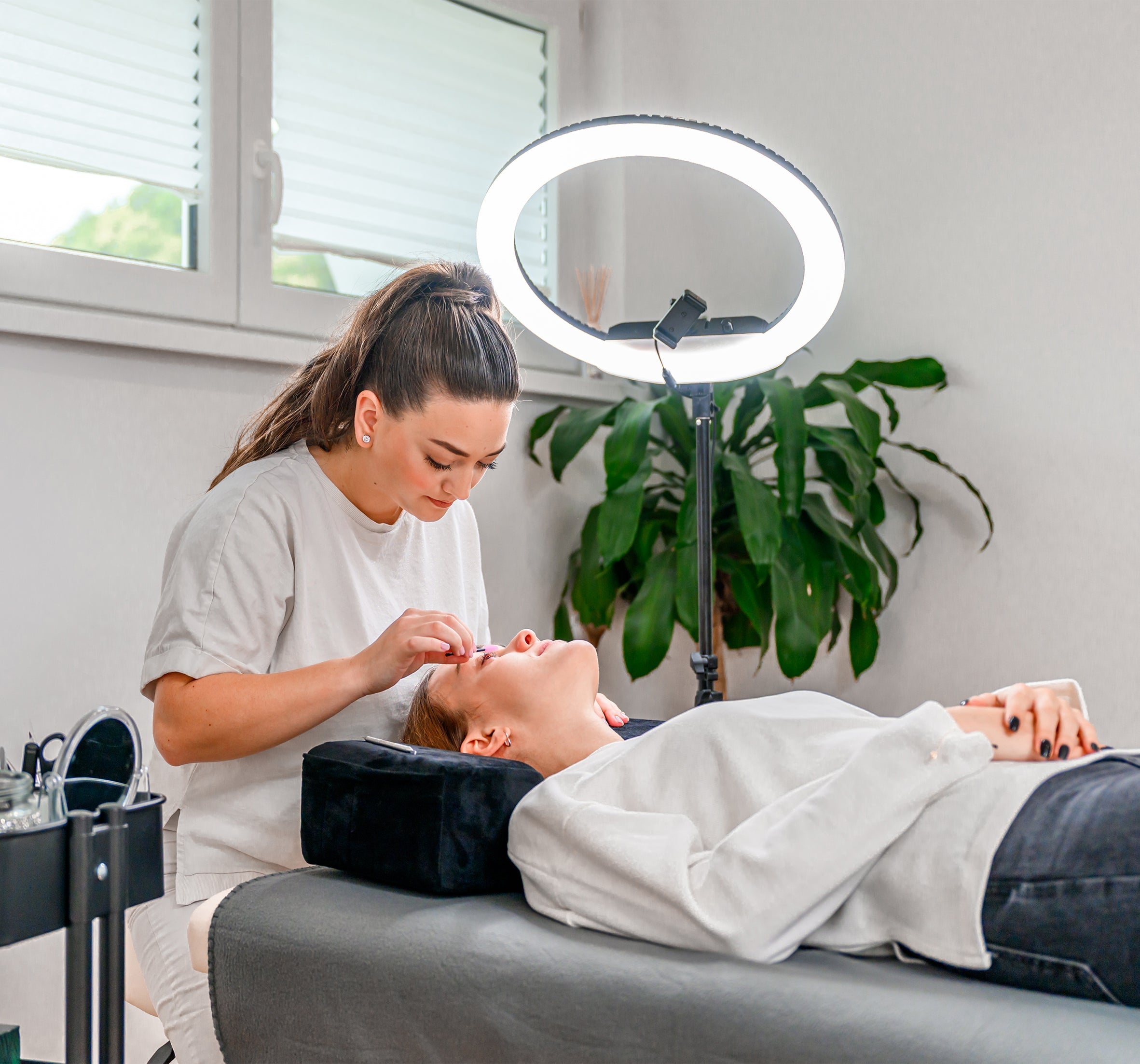Professional lash artist applying eyelash extensions