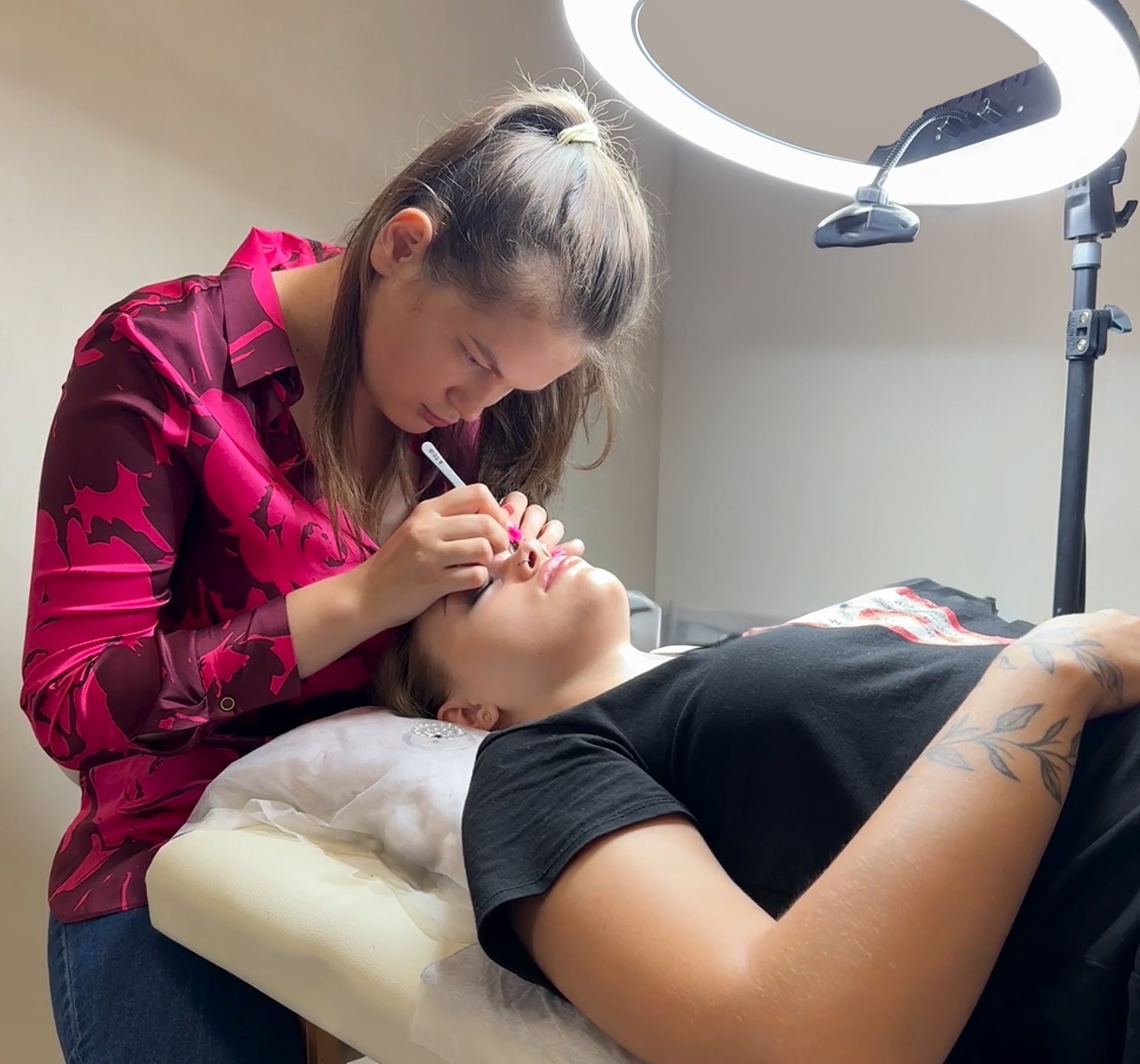 a lash professionsal performing the procedure on her client