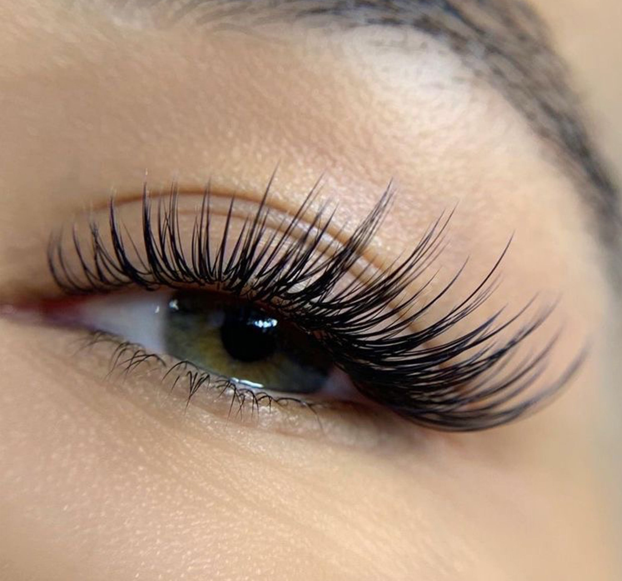 a closeup of an eye with eyelash extensions on