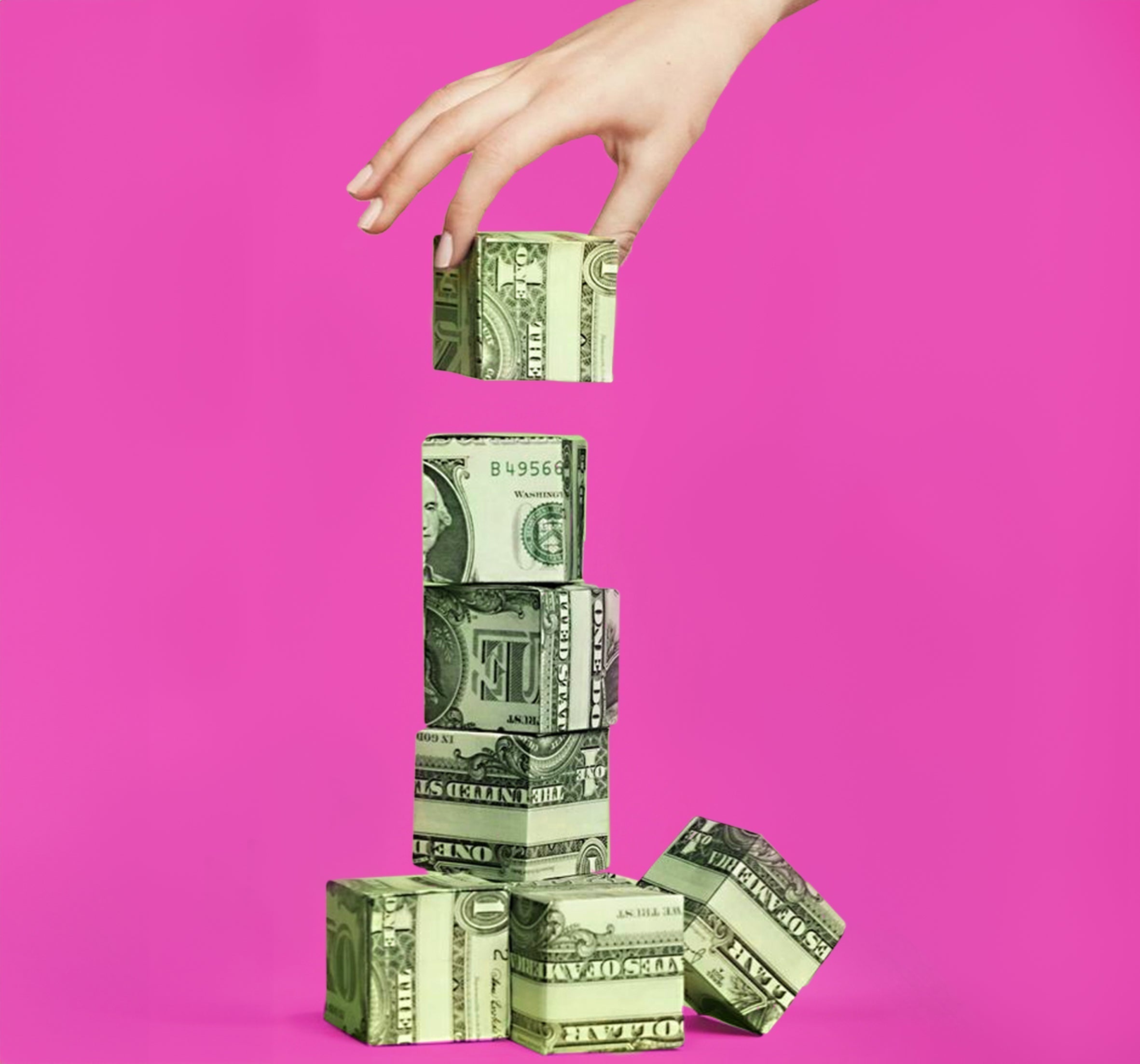 a hand building tower with money