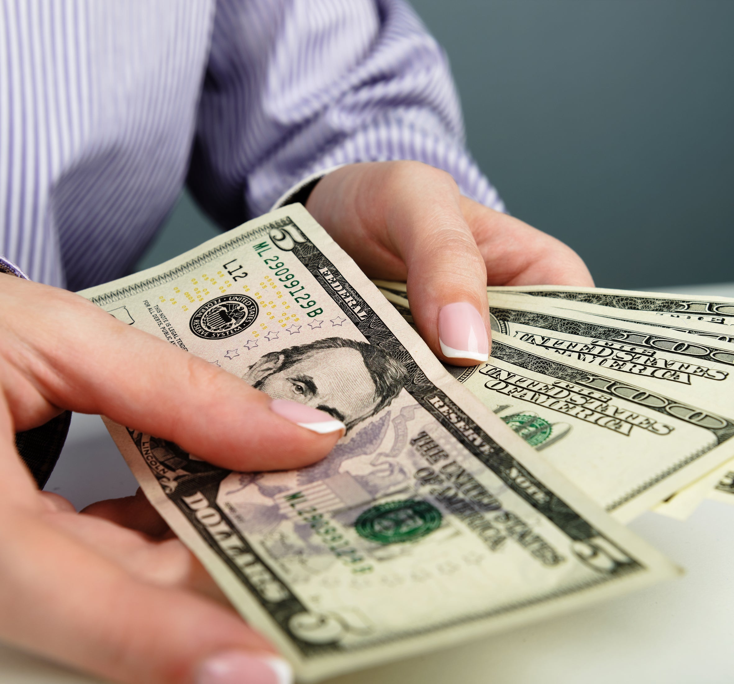 hands holding some money