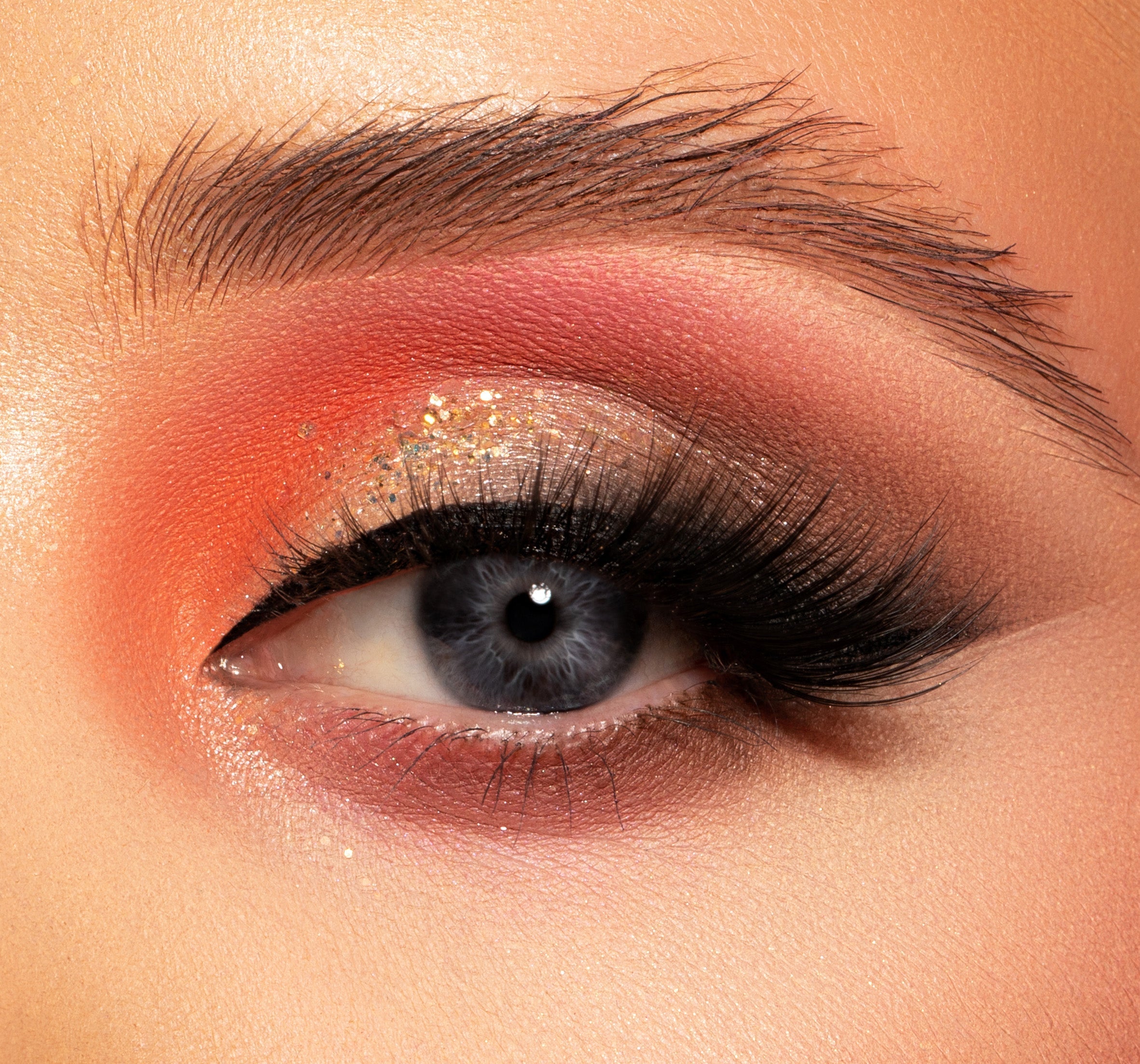 a closeup of an eye with lash extensions on and makeup
