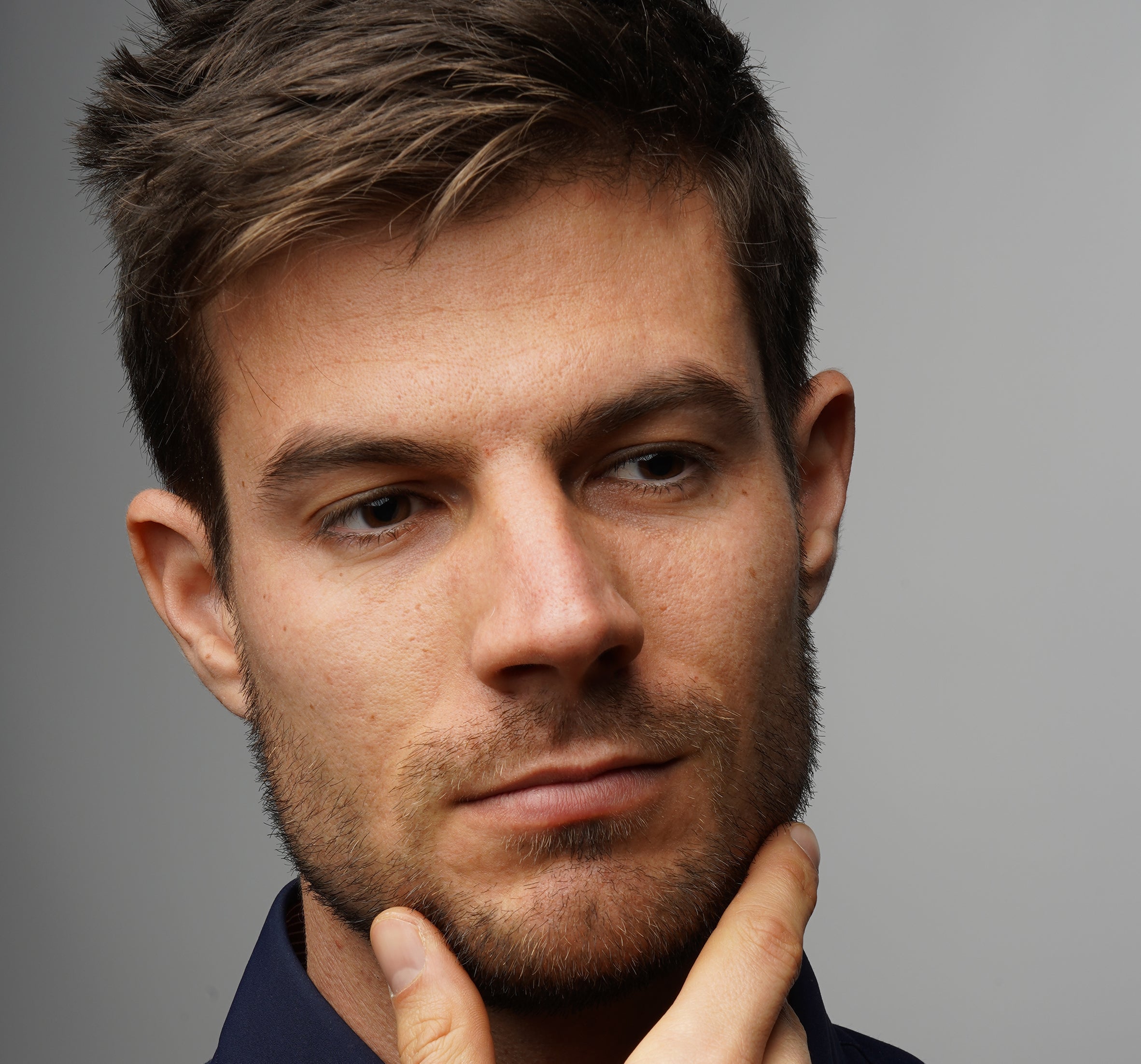 a man scratching his chin and thinking