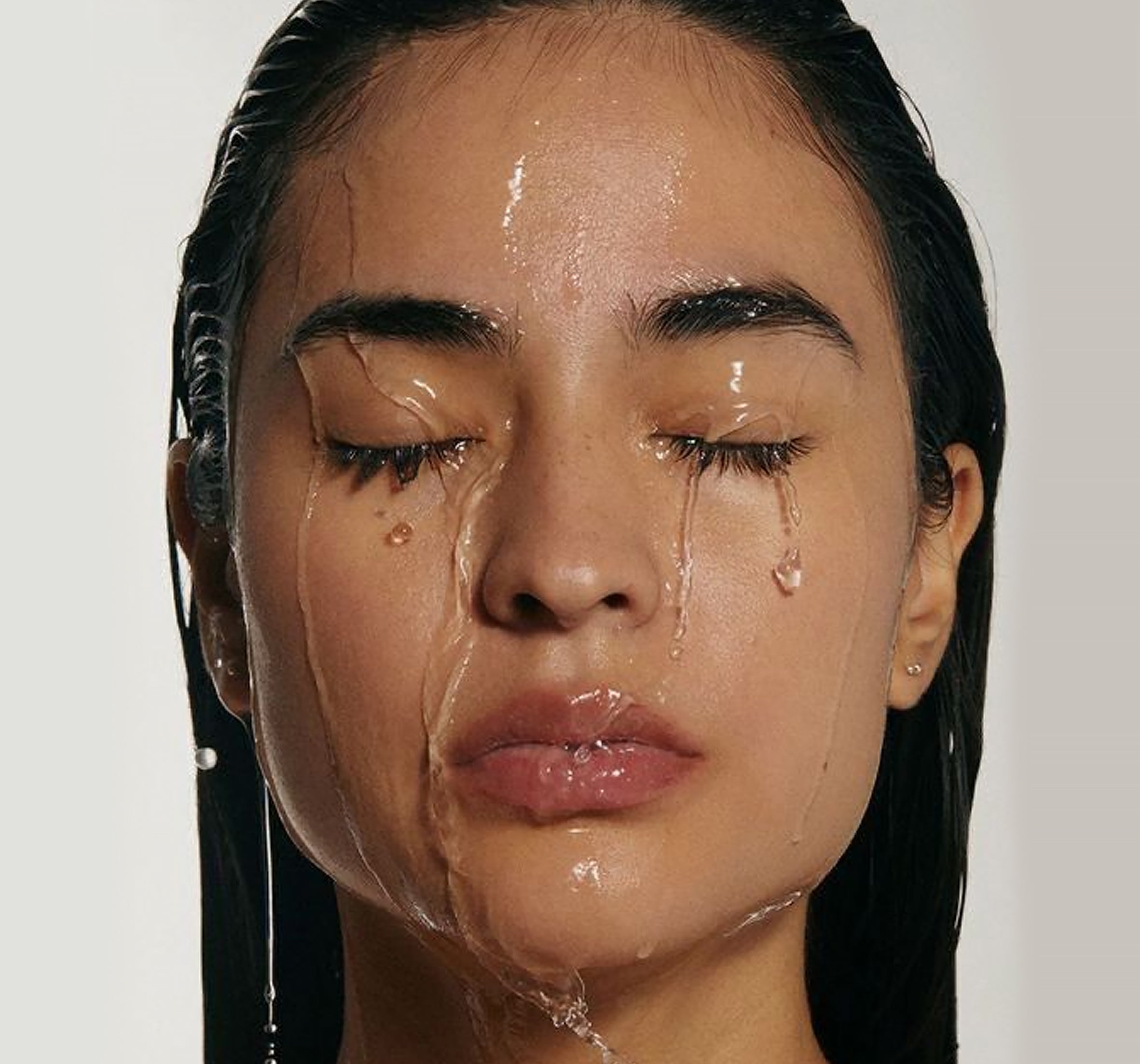 a face of the woman with dripping water