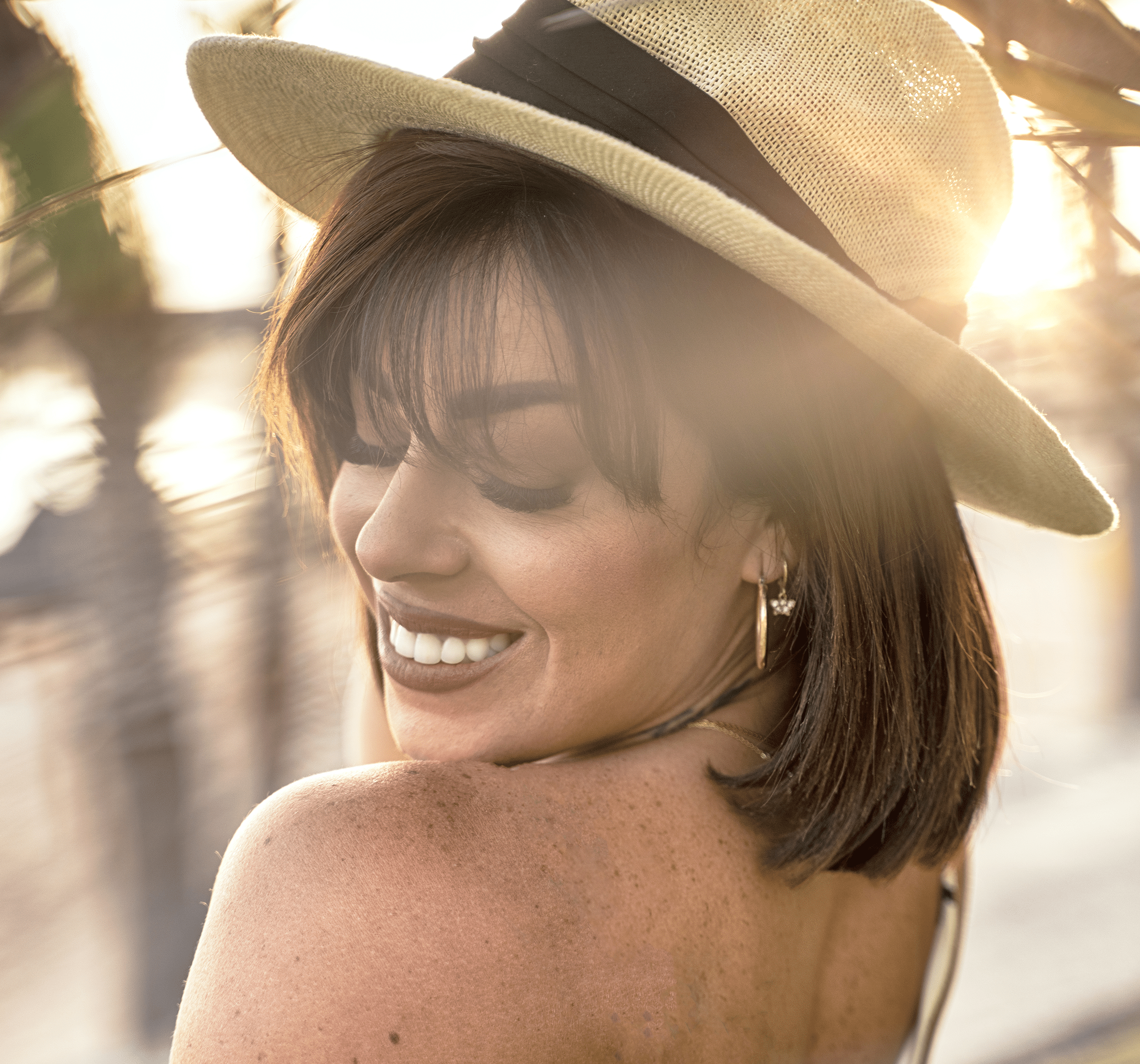 a woman in hat smiling