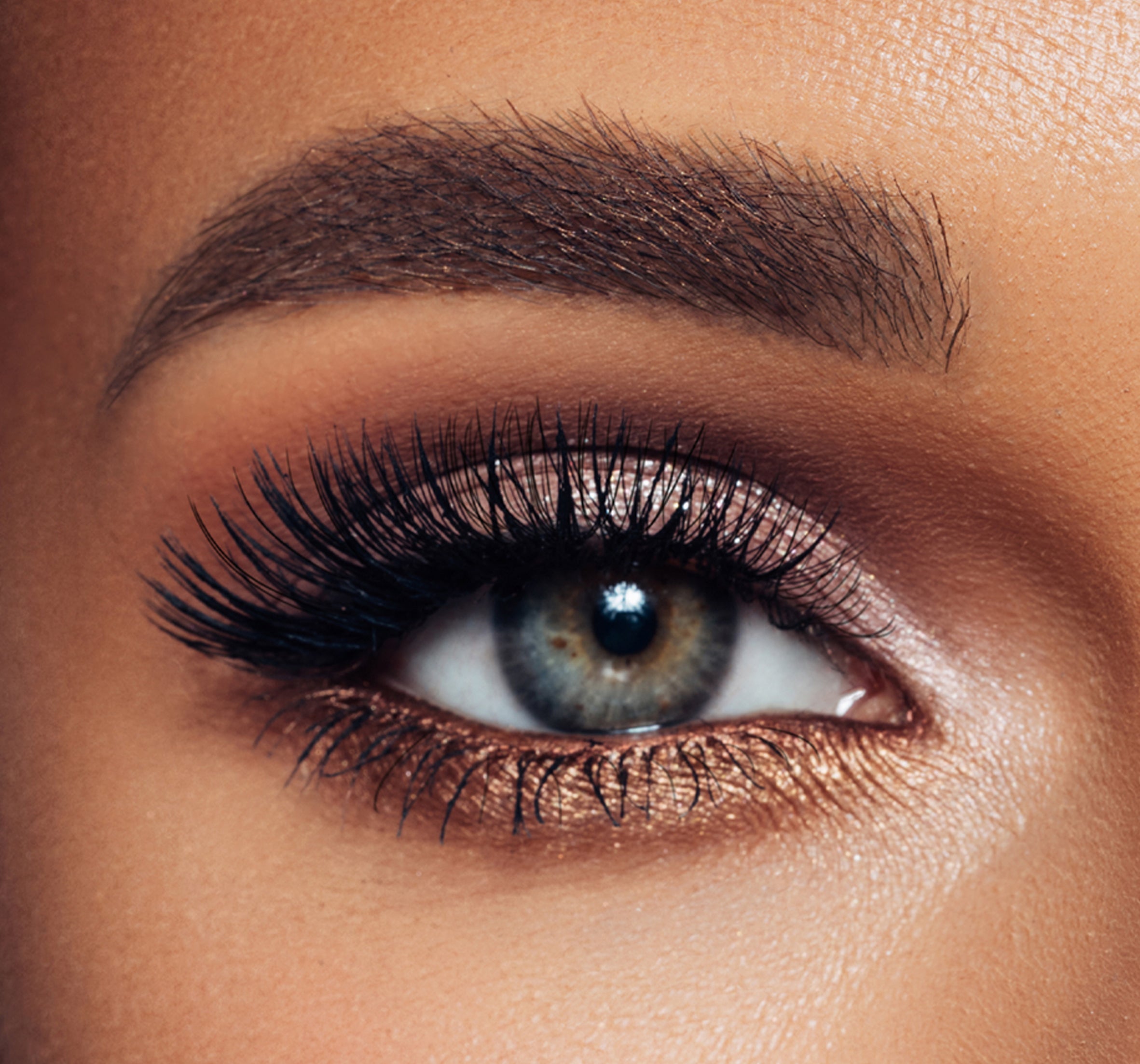 an eye with makeup and extensions on