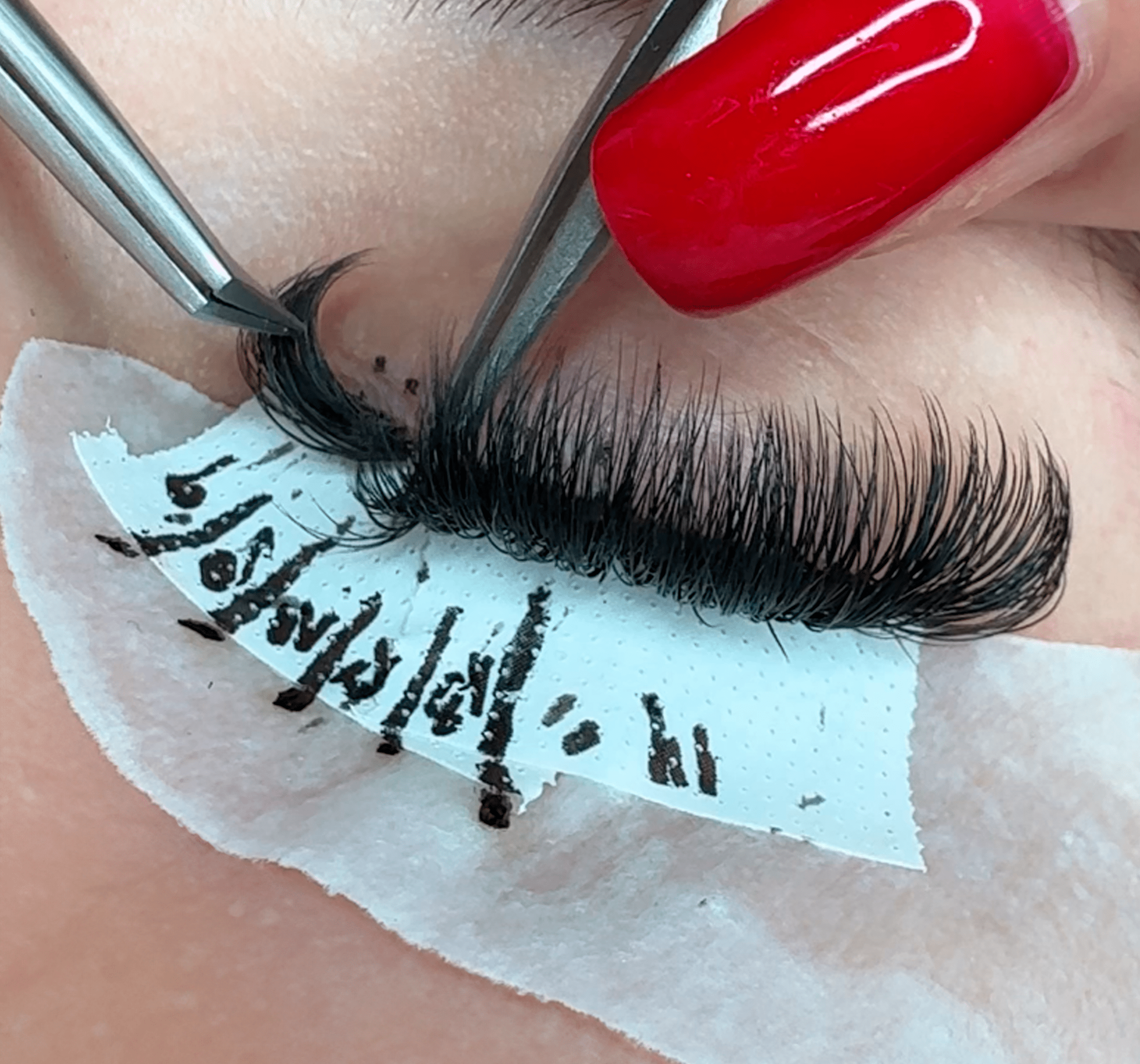 a closeup of an while applying the extensions