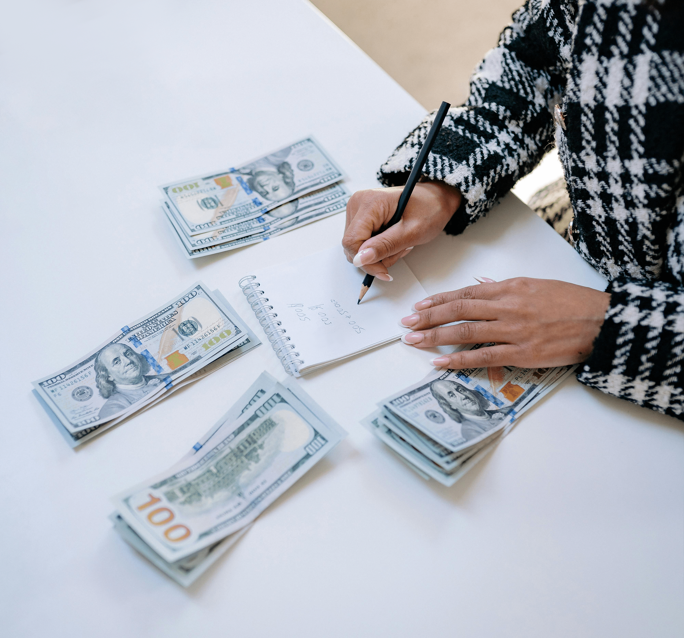 several piles of money and a woman with a notepad