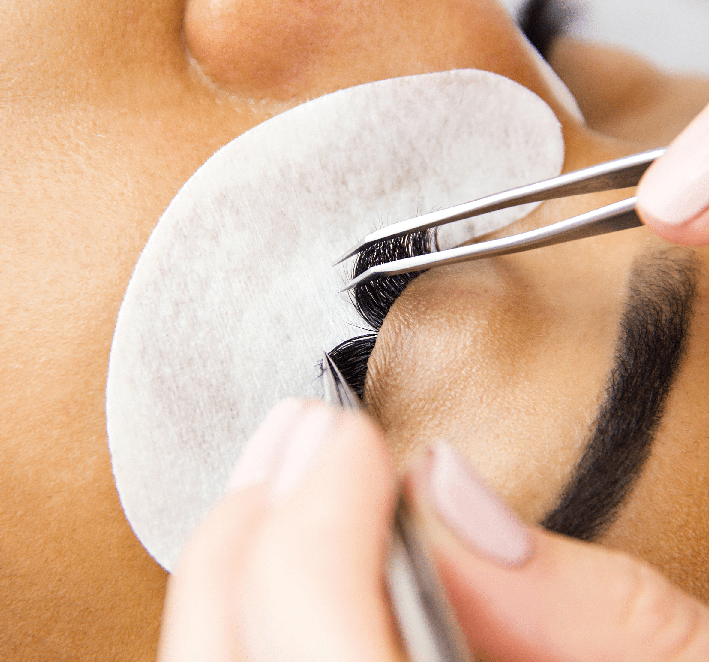 Professional lash artist applying eyelash extensions