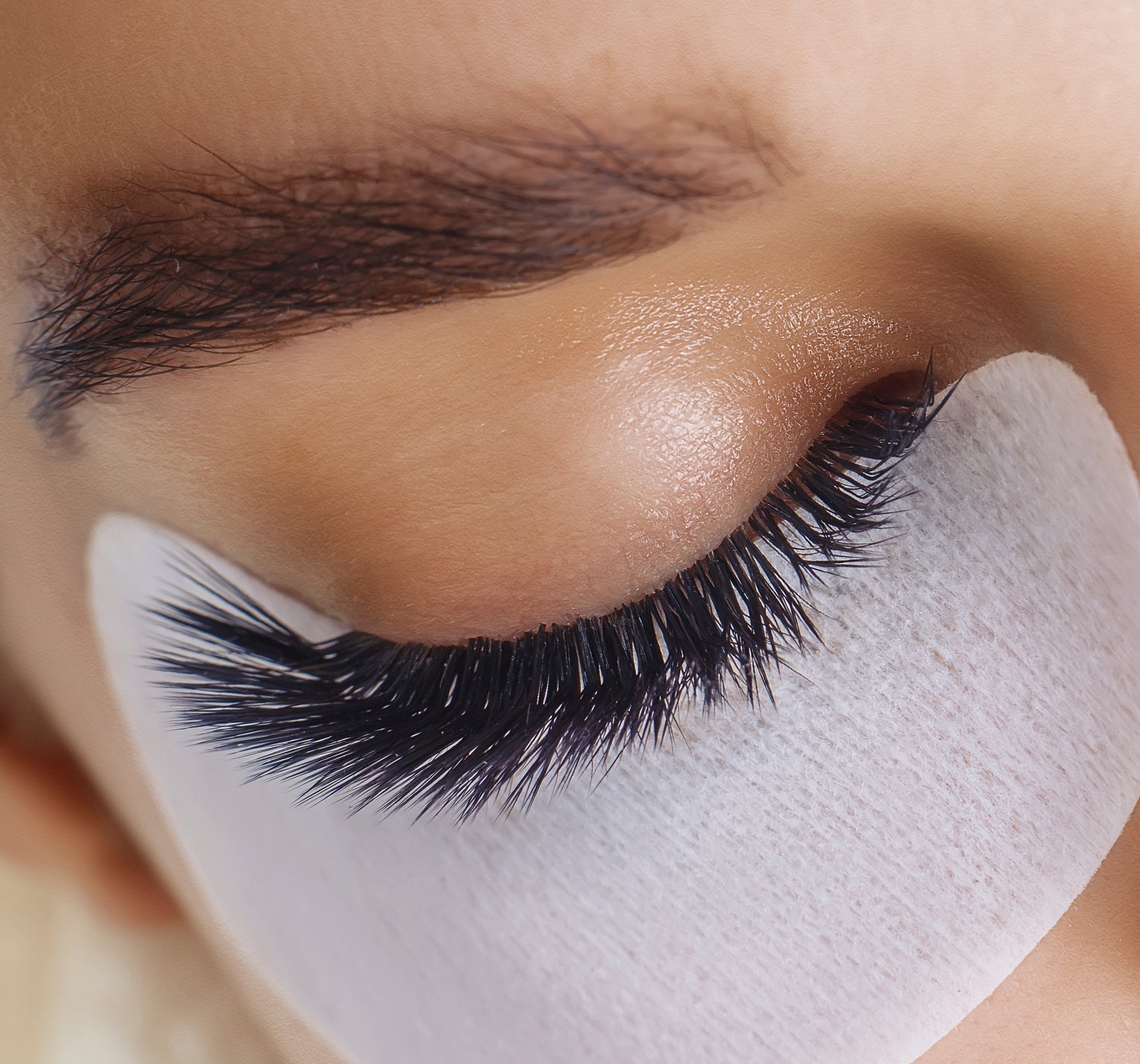 patched down eye with lash extensions on