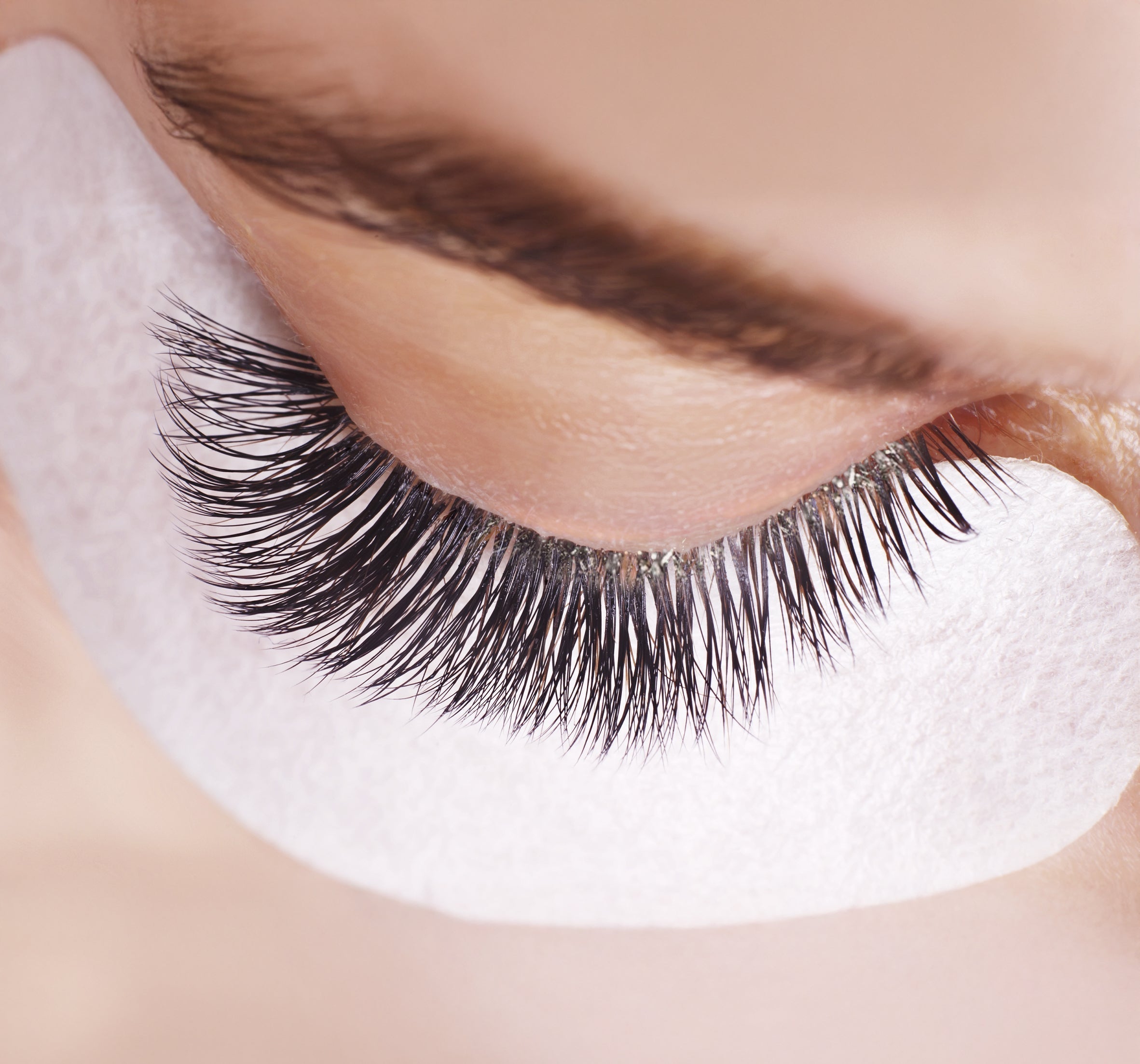 a closed eye with eyelash extensions on